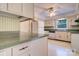 Well-lit kitchen featuring ample counter space, vintage cabinets, and classic appliances at 1658 Buckingham Ave, Gastonia, NC 28054