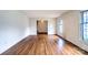 Spacious living room with hardwood floors, large windows, and bright white walls at 1658 Buckingham Ave, Gastonia, NC 28054