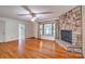Cozy living room featuring a striking stone fireplace and hardwood floors at 1658 Buckingham Ave, Gastonia, NC 28054