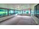 Bright sunroom featuring many windows and a ceiling fan at 1658 Buckingham Ave, Gastonia, NC 28054