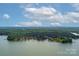 Expansive lake view with a tree-lined shoreline, showcasing the natural beauty of the area at 176 Windwood Ln, Troutman, NC 28166