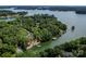 Aerial view of waterfront property, lush greenery, and private docks on a serene lake setting at 176 Windwood Ln, Troutman, NC 28166