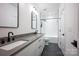 Bathroom featuring a double vanity with modern fixtures, and a shower/tub combo with subway tile at 176 Windwood Ln, Troutman, NC 28166