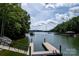 Scenic lake view with a dock and boat slips, perfect for waterfront living at 176 Windwood Ln, Troutman, NC 28166
