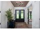 Welcoming foyer with hardwood floors, stylish rug, and elegant decor at 176 Windwood Ln, Troutman, NC 28166