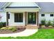 Charming front porch featuring brick steps, rustic columns, and landscaped garden at 176 Windwood Ln, Troutman, NC 28166