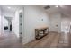 Upstairs hallway with hardwood floors featuring natural light and white doors at 176 Windwood Ln, Troutman, NC 28166