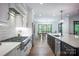 Open-concept kitchen featuring a gas range, stainless steel appliances, and a view into the dining area at 176 Windwood Ln, Troutman, NC 28166