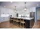 Modern kitchen with a large island, white cabinetry, and stainless steel appliances at 176 Windwood Ln, Troutman, NC 28166