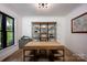 Bright home office with large desk, shelving unit, and natural light at 176 Windwood Ln, Troutman, NC 28166