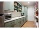 Walk-in pantry with custom cabinets, open shelving, and a stainless steel refrigerator at 176 Windwood Ln, Troutman, NC 28166