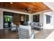 Inviting covered patio with stylish furniture, wood ceiling and view through sliding glass doors at 176 Windwood Ln, Troutman, NC 28166
