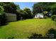 Expansive backyard featuring lush green lawn, storage shed, and mature trees providing shade and privacy at 201 W 19Th St, Kannapolis, NC 28081