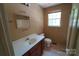 Well-lit bathroom with updated vanity, toilet, mirror, and a shower/tub combo at 201 W 19Th St, Kannapolis, NC 28081