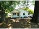 Charming bungalow-style home with a covered front porch and well-maintained yard with mature shade trees at 201 W 19Th St, Kannapolis, NC 28081