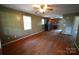 Open-concept living room seamlessly flows into the kitchen with hardwood floors and a ceiling fan at 201 W 19Th St, Kannapolis, NC 28081