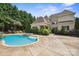 Stunning backyard with a spacious pool and lush landscaping, perfect for outdoor relaxation at 20635 Queensdale Dr, Cornelius, NC 28031