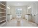Elegant bathroom with pedestal tub, double vanities, large mirrors, and beautiful lighting at 20635 Queensdale Dr, Cornelius, NC 28031