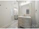 Bathroom with a double sink vanity, marble countertops and floors at 20635 Queensdale Dr, Cornelius, NC 28031