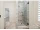 Bathroom featuring a tiled walk-in shower with a glass door at 20635 Queensdale Dr, Cornelius, NC 28031