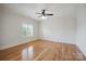 Spacious bedroom featuring hardwood floors, neutral paint, ceiling fan and natural light at 20635 Queensdale Dr, Cornelius, NC 28031