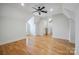 Spacious bedroom boasts hardwood floors and a ceiling fan, with a connecting doorway at 20635 Queensdale Dr, Cornelius, NC 28031