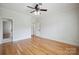 Spacious bedroom with hardwood floors, neutral paint, and ceiling fan at 20635 Queensdale Dr, Cornelius, NC 28031