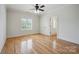 Bright bedroom with hardwood floors, natural light, and a ceiling fan at 20635 Queensdale Dr, Cornelius, NC 28031