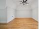 Bedroom featuring hardwood floors, a ceiling fan, neutral walls, and lots of space at 20635 Queensdale Dr, Cornelius, NC 28031