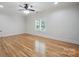 Bedroom with hardwood floors, natural light, and ceiling fan at 20635 Queensdale Dr, Cornelius, NC 28031