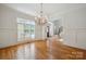 Formal dining room featuring wainscoting, hardwood floors, and an elegant chandelier at 20635 Queensdale Dr, Cornelius, NC 28031