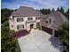 Stunning two-story home with a three car garage, balcony, manicured lawn, and beautiful landscaping at 20635 Queensdale Dr, Cornelius, NC 28031
