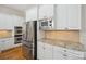 This kitchen features a stainless steel refrigerator, built-in microwave, and granite countertops at 20635 Queensdale Dr, Cornelius, NC 28031