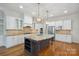 Beautiful kitchen with white cabinets, stainless steel appliances, and a center island with seating at 20635 Queensdale Dr, Cornelius, NC 28031