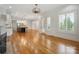 Open-concept living and dining area with hardwood floors, great natural light, and elegant finishes at 20635 Queensdale Dr, Cornelius, NC 28031
