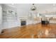 Spacious living room boasts hardwood floors, a fireplace and an open layout flowing into the kitchen at 20635 Queensdale Dr, Cornelius, NC 28031