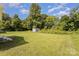 Spacious backyard with lush green grass and a storage shed, providing ample space at 210 Marshall St, Rock Hill, SC 29730