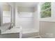 Bathroom featuring a white vanity, window, shower and updated finishes at 210 Marshall St, Rock Hill, SC 29730