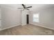 Large bedroom with a ceiling fan, fresh paint, and modern floors with black door at 210 Marshall St, Rock Hill, SC 29730