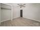 Bedroom featuring fresh paint, ceiling fan, new closet and modern flooring at 210 Marshall St, Rock Hill, SC 29730