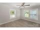 Bright bedroom with a ceiling fan, fresh paint, two windows and modern flooring at 210 Marshall St, Rock Hill, SC 29730