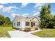 Charming single-story home with white siding, a welcoming front porch, and a freshly poured concrete driveway at 210 Marshall St, Rock Hill, SC 29730