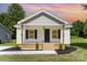 Charming home featuring a covered front porch, black shutters, and beautifully landscaped yard at 210 Marshall St, Rock Hill, SC 29730