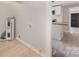 Bright laundry area with modern flooring, updated utilities and glimpse of kitchen at 210 Marshall St, Rock Hill, SC 29730