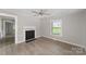 Inviting living room featuring fresh paint, a decorative fireplace, and durable laminate floors throughout at 210 Marshall St, Rock Hill, SC 29730