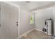 Spacious mud room with rear door access, adjacent water heater, and laminate flooring at 210 Marshall St, Rock Hill, SC 29730