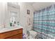 Bright bathroom with modern fixtures, chevron shower curtain, and ample counter space at 219 Mccord St, Charlotte, NC 28216