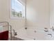 Modern bathtub with neutral colors and decor, including a window for natural lighting at 219 Mccord St, Charlotte, NC 28216