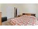 Bright bedroom with neutral walls, a floral bedspread, and easy access to a closet and hallway at 219 Mccord St, Charlotte, NC 28216