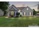 Charming single-story home features a well-manicured lawn and traditional architectural details at 219 Mccord St, Charlotte, NC 28216